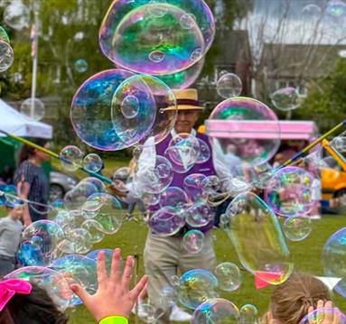 Children enjoying the bubble man at the 2025 summer play days