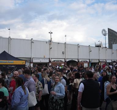 The image shows Trent Bridge Cricket Ground being entered by a large crowd. 