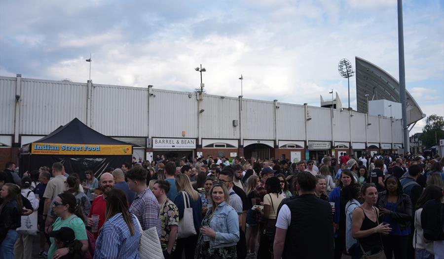 The image shows Trent Bridge Cricket Ground being entered by a large crowd.
