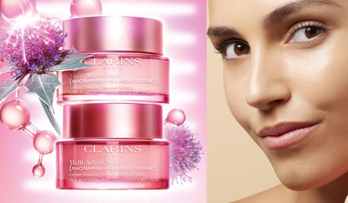 Photo of a model and a stack of Clarins products