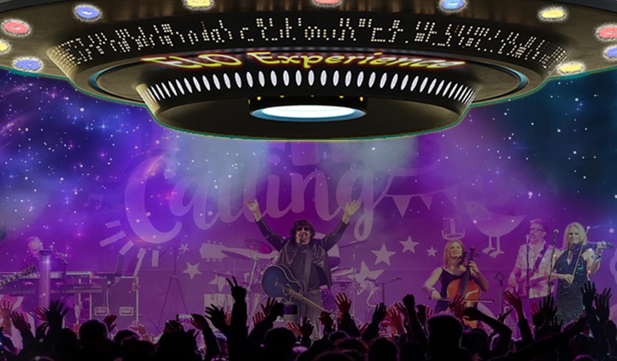 A large electric light photoshopped over an image of a stage