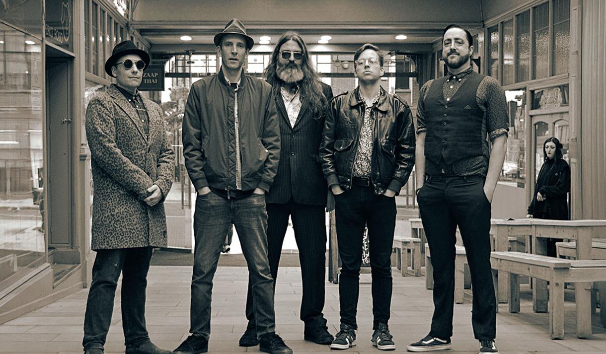 group of 5 men in black and white