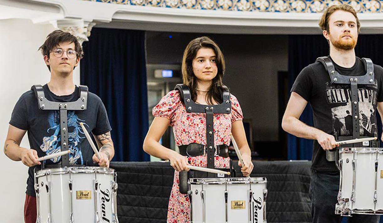 people playing marching drums