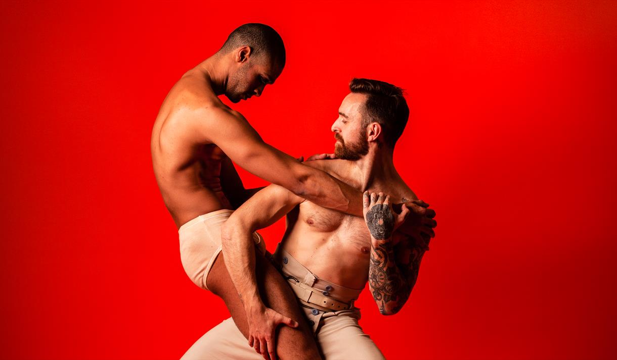 Photo of two male dancers mid-routine