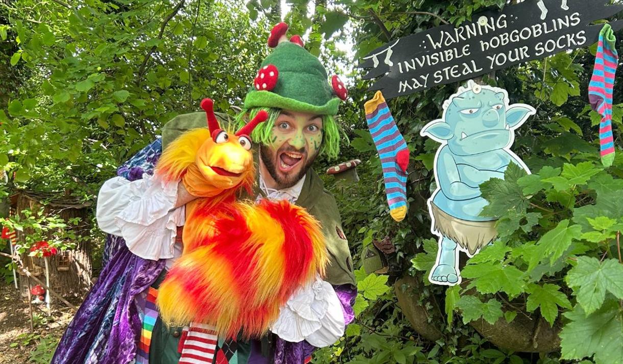 Man dressed up in front of a forest