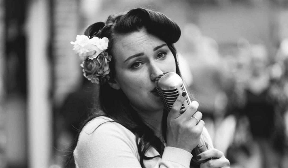woman singing into a mic
