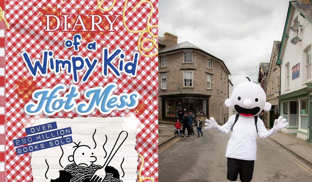 Graphic for the event including illustrations fro the book and the character of Greg Heffley come to life in a mascot sized costume