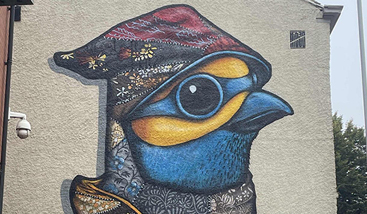 Graffiti of a bird on the side of a building