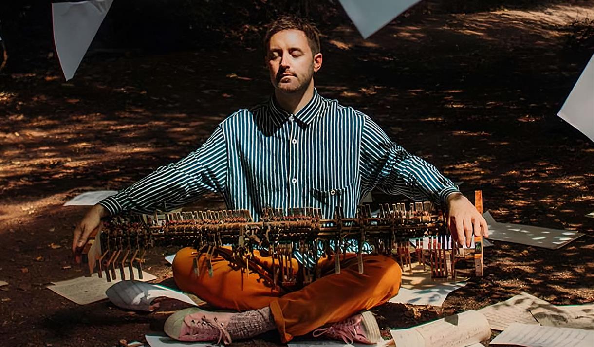 Photo of a musicican sitting on the floor