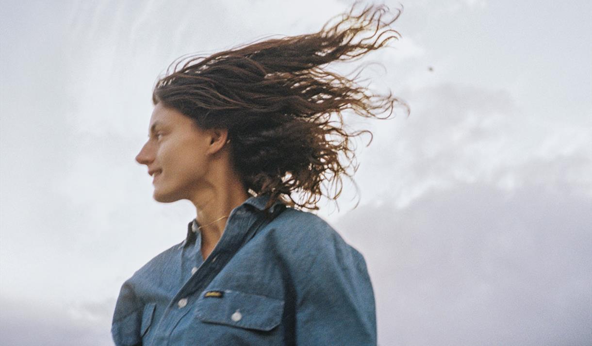 Image shows Sophie Jamieson on against dramatic sky on blustery day