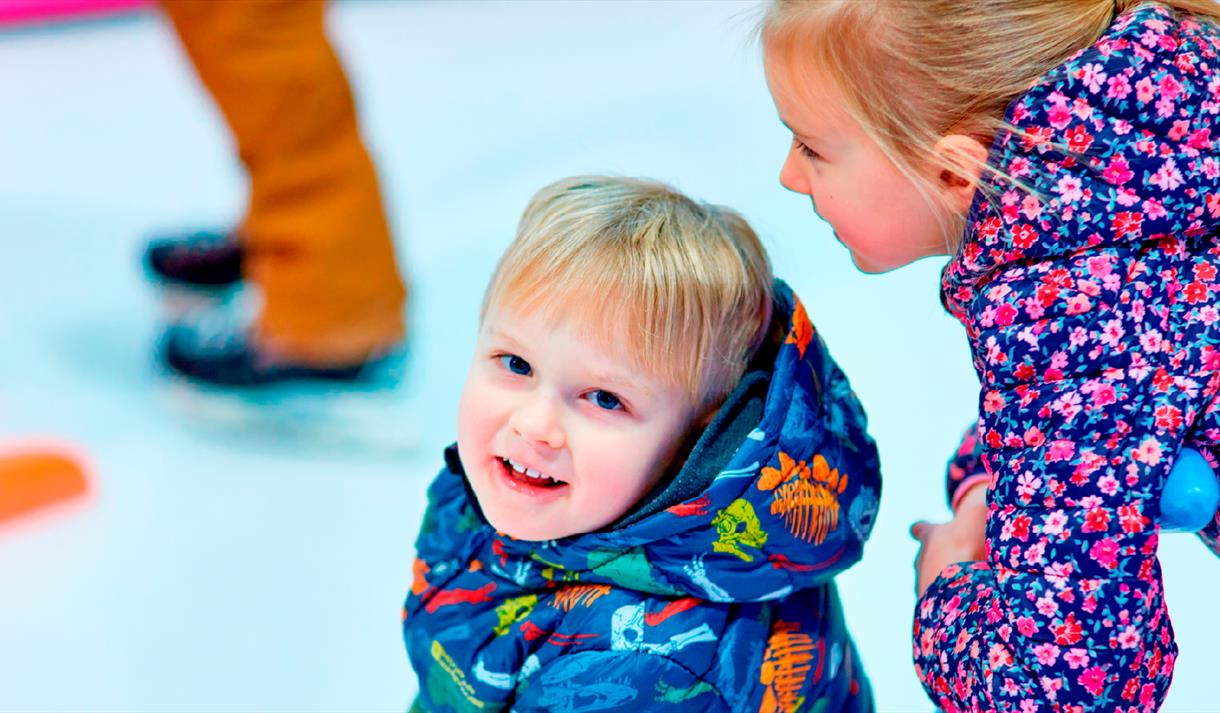 Photo of two young girls enjoying an ice-skating session