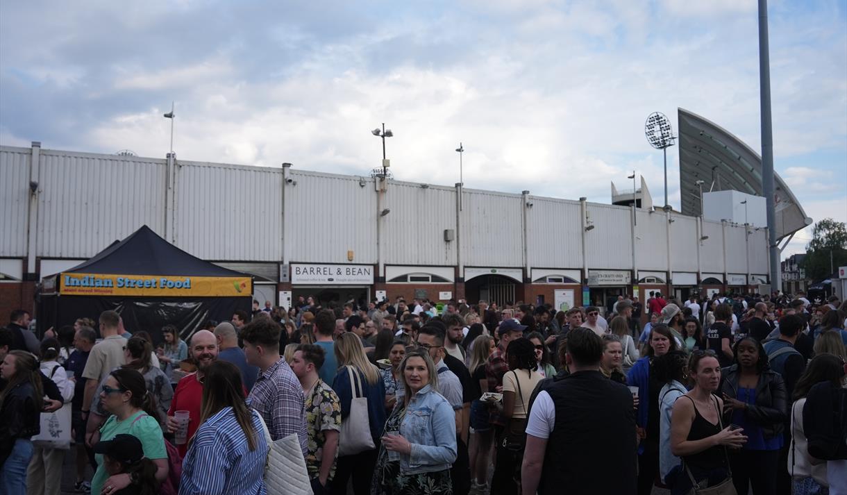The image shows Trent Bridge Cricket Ground being entered by a large crowd.