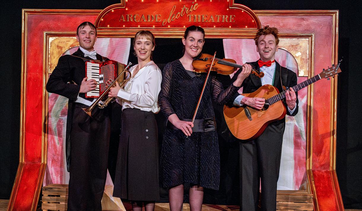 Photo of musicians sanding on a stage