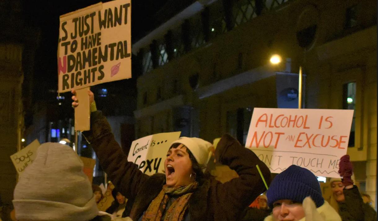 A group of demonstrators holding up signs protesting for women's rights