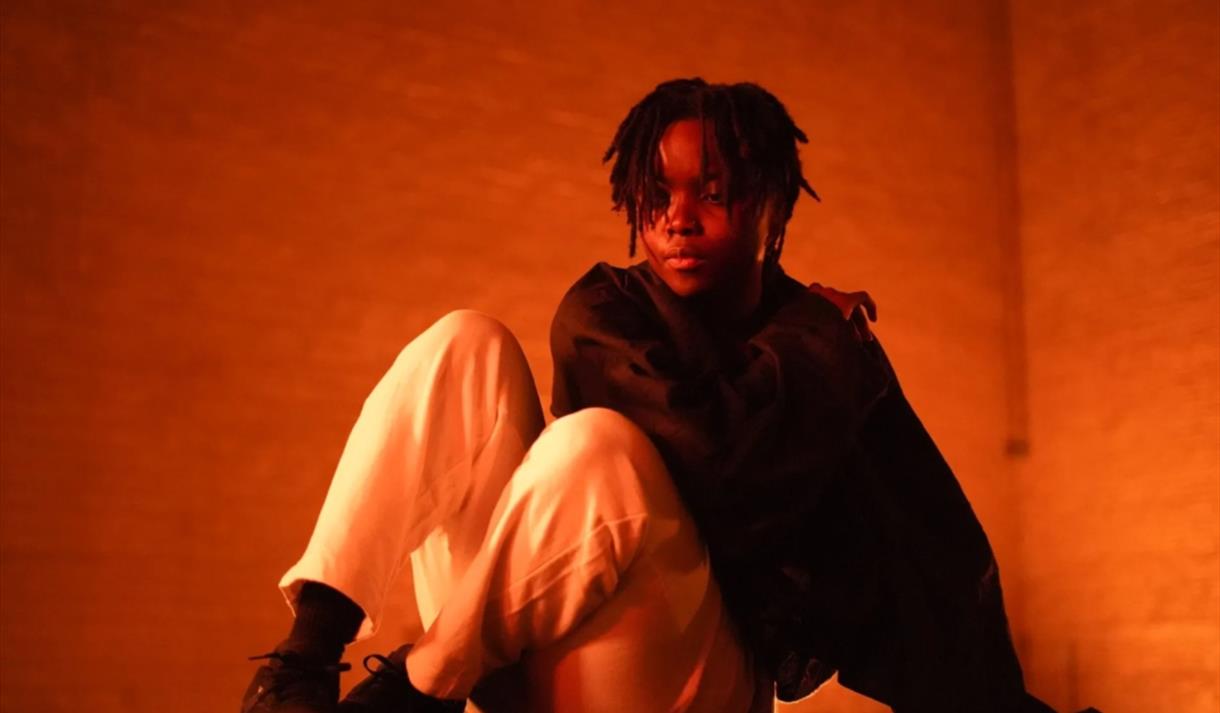 Image of young person sat down on the floor