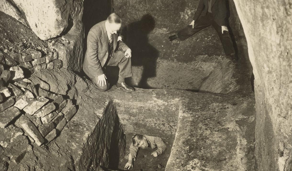 Black and white photo of three men exploring Nottingham's cave system