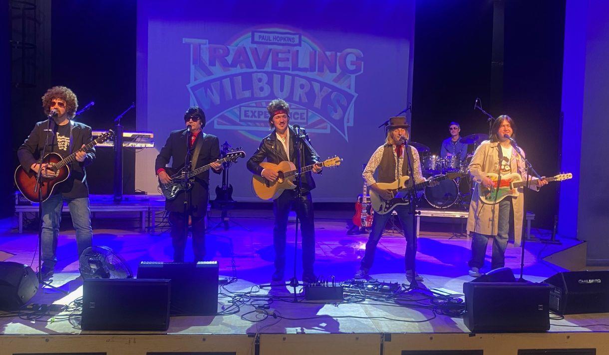 Travelling Wilburys tribute band performing on stage