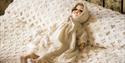 porcelain doll on bed