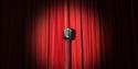 Microphone in front of a red stage curtain