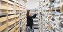 Member of staff moving documents in the store room