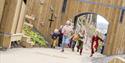 Group of 6 young children having fun at Nottingham Castle's outdoor play area.