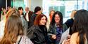 Photo of attendees mignling at an exhibition opening
